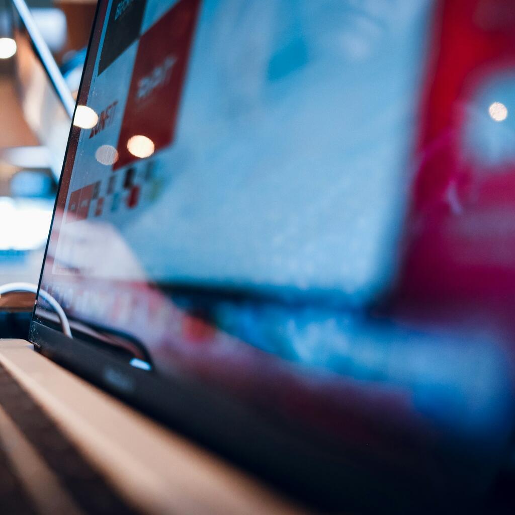Person working on laptop at a coffee shop representing freelance remote work