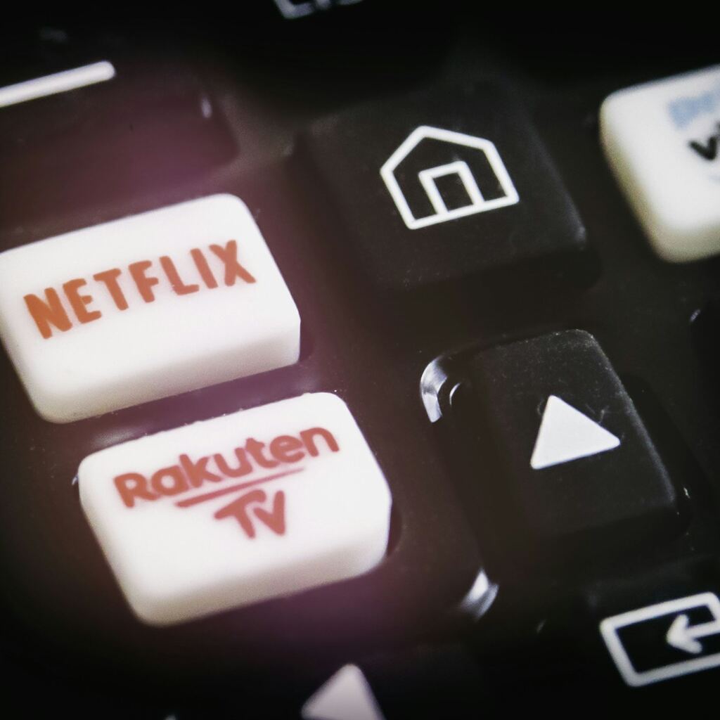 Netflix and streaming service buttons on TV remote representing subscription economy in Algeria